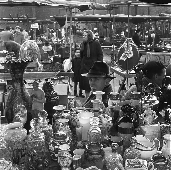Antique dealer and his stall at the New Caledonian Street Market. 22nd March 1954