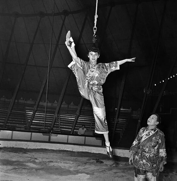 Anzti Loops her hair to go on hook in circus act. November 1952 C5390