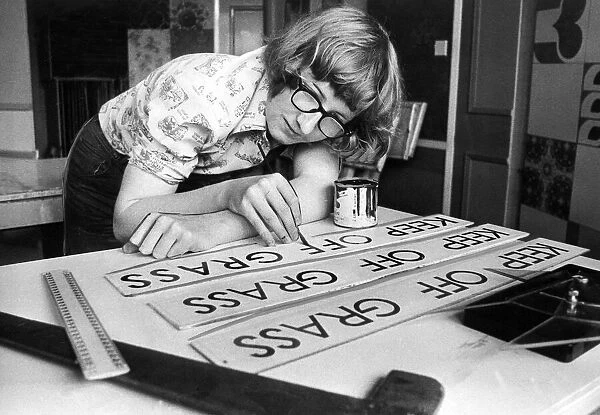 Apprentice Norman Armstrong, aged 17, at work for the coucil as a sign writer