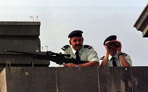 Armed Security men on rooftop August 1998 keep watch during the visit of Prince