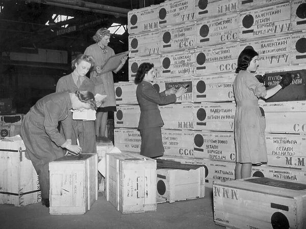Arms for Russia. Girls at the Ordinance factory stencilling suupplies for the USSR with