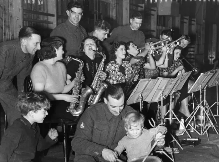 Framed Print : An Army band plays with wives and girlfriends during some off duty leisure time in Framed Print : An Army band plays with wives and girlfriends during some off duty leisure time in