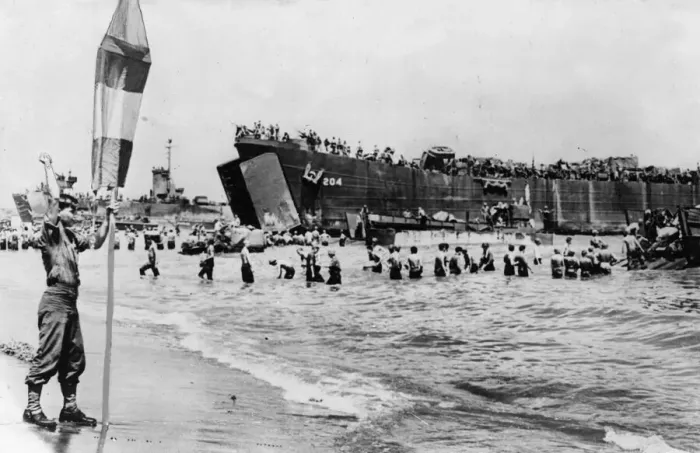 Framed Print : A US Army beach master seen here guiding landing craft to a safe beach area to unload Framed Print : A US Army beach master seen here guiding landing craft to a safe beach area to unload