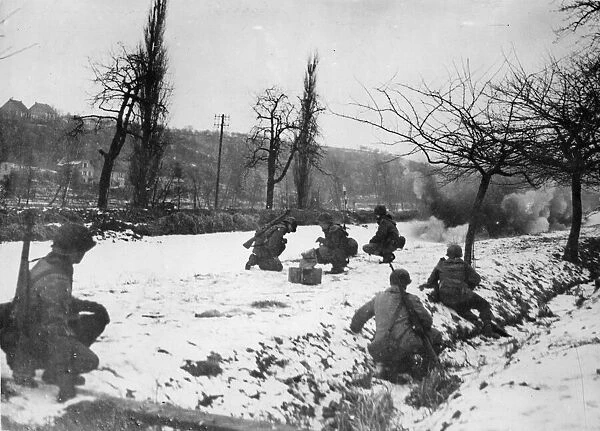 US Army engineers crouch in the foreground as a TNT charge breaks up the ice in
