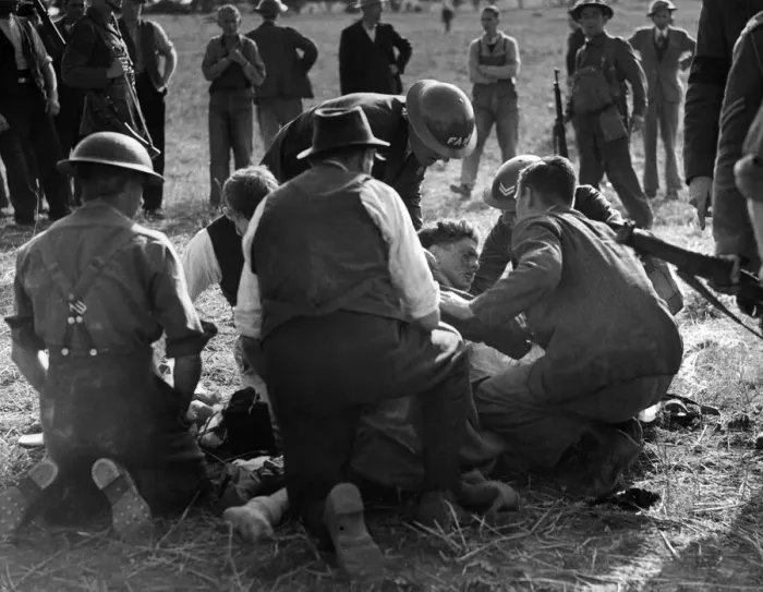 Framed Print : Army and FAP members attend to a German pilot in England who parachuted to the ground Framed Print : Army and FAP members attend to a German pilot in England who parachuted to the ground