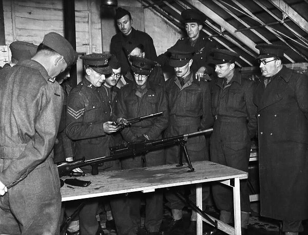 Army officers are given a demonstration on how to strip down a Bren Gun