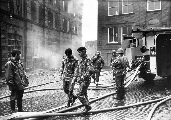 Army personnel take over the duties of the firefighter during the firemen