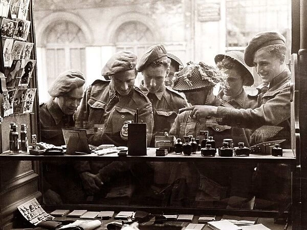 Army Soldiers looking through a shop window - June 1944 for souvenirs to send back