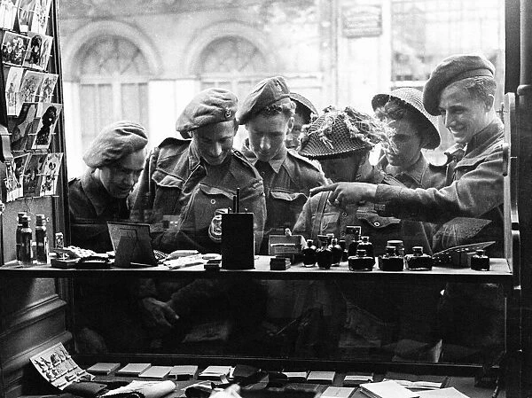 Army Soldiers looking through a shop window - June 1944 for souvenirs to send back home