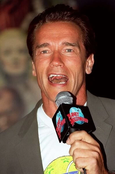 Arnold Schwarzenger Actor July 98 At Planet Hollywood restaurant in london holding