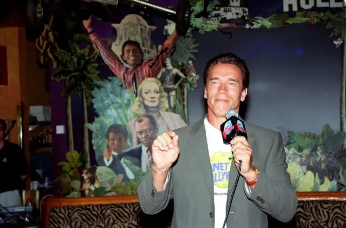 Framed Print : Arnold Schwarzenger Actor July 98 At Planet Hollywood restaurant in london holding Framed Print : Arnold Schwarzenger Actor July 98 At Planet Hollywood restaurant in london holding