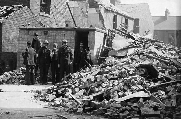 ARP personnel, Air raid warden help to search for survivors in an East Hull street after