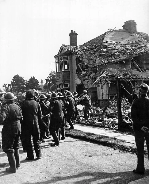 ARP pulling down walls following an air raid attack, England. April 1940