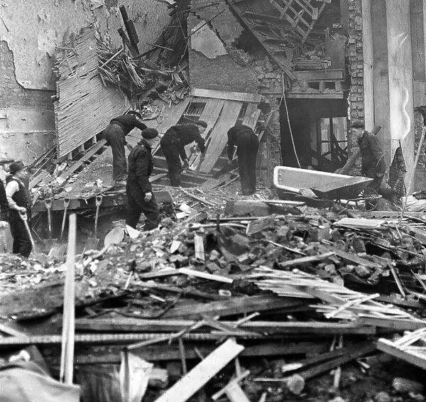 ARP workers searching the debris of one of the bombed houses in London for a victim