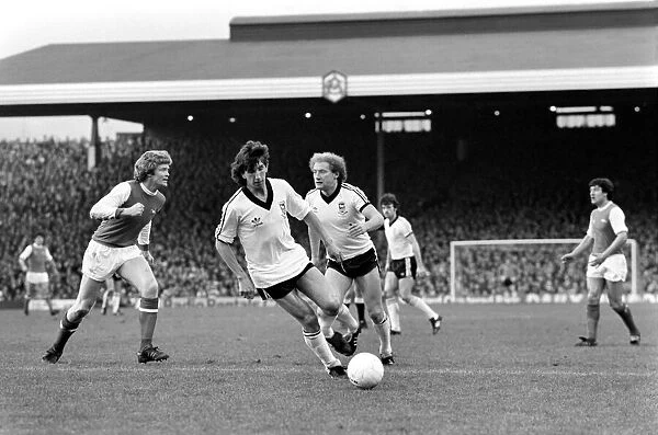 Arsenal (1) v. Ipswich (1). Alan Brazil (right) sends Willie Young the wrong way