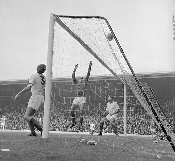 Arsenal defenders Billy McCullough and Don Howe assist goalkeeper Jim Furnell to put this