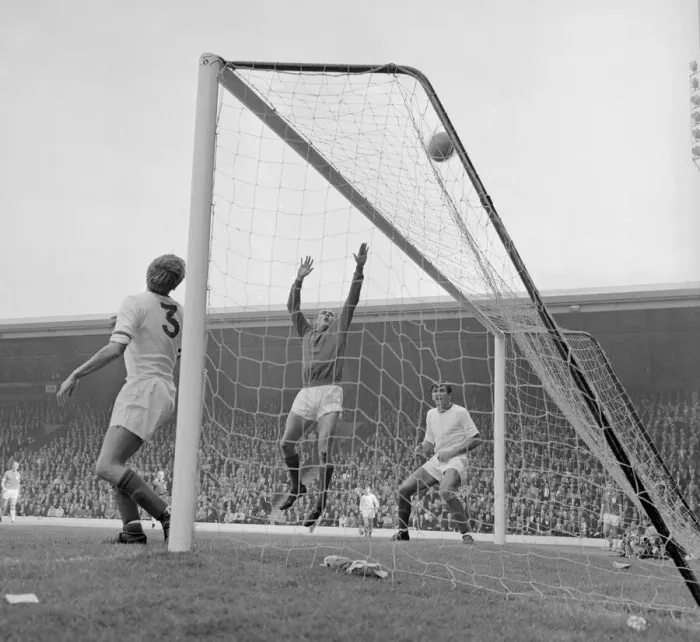 Framed Print : Arsenal defenders Billy McCullough and Don Howe assist goalkeeper Jim Furnell to put this