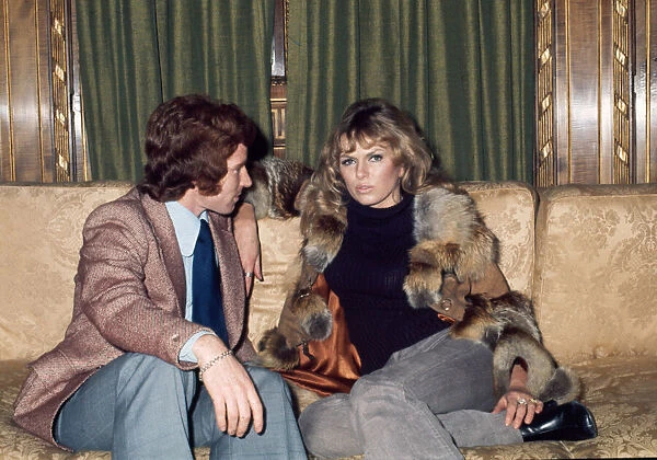 Arsenal footballer Alan Ball sitting on a sofa talking to actress June Ege during a team