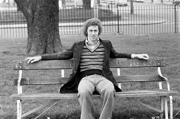 Arsenal footballer Charlie George sitting on a bench at Hackney marshes February