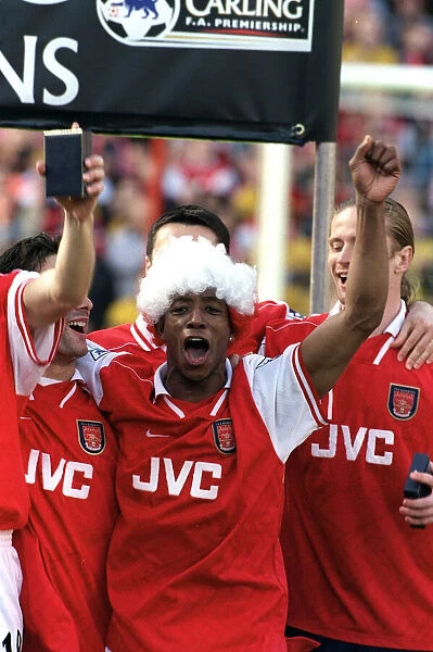 Arsenal footballer Ian Wright celebrates with team mates after the 4-0 victory over