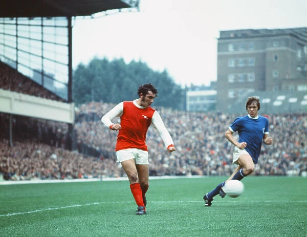 Arsenal footballer Ray Kennedy in action against Leicester City watched by David Nish