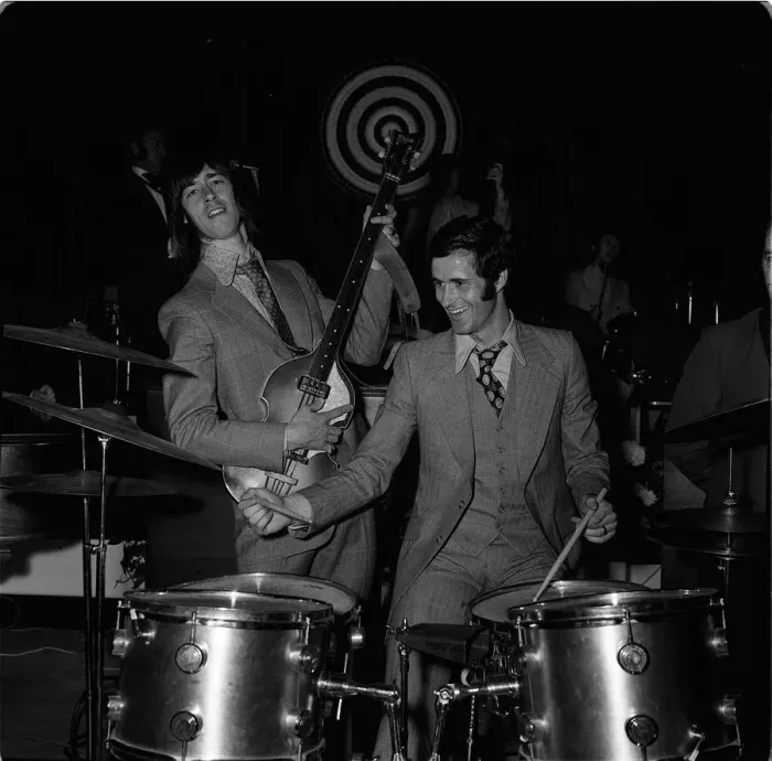 Framed Print : Arsenal footballers George Graham and Charlie George dressed in 1960s style clothing