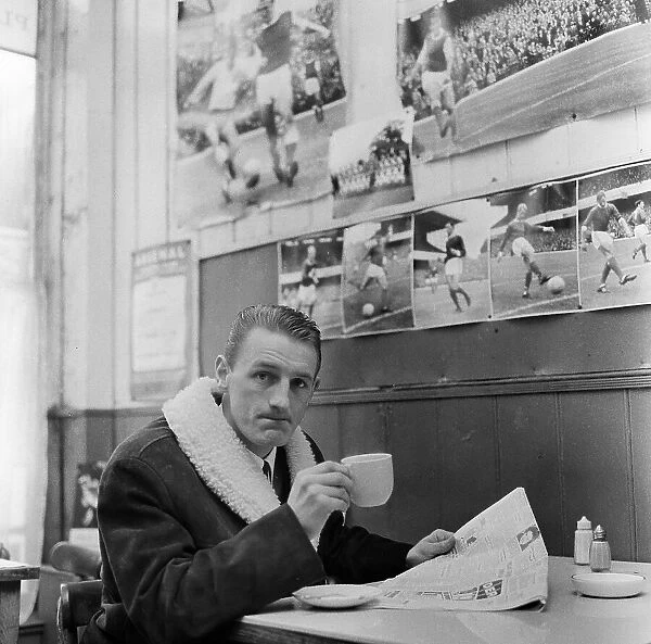 Arsenal inside forward George Eastham sits with a cup of tea in a cafe near his club's Highbury ground after hearing he had been dropped for the upcoming away match against Stoke City