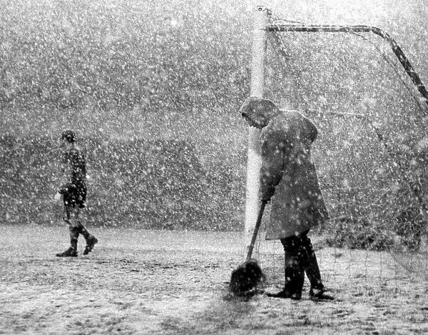 Arsenal v. Sheffield Wednesday. A Groundsman sweeps the line clear while Peter