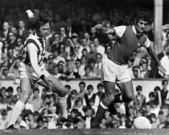 Framed Print : Arsenal v West Bromwich Albion Frank McLintock of Arsenal leaves Jeff Astle