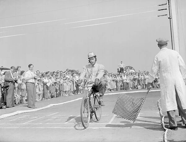 Arthur English crosses the finish line to take the chequered flag to win his race against