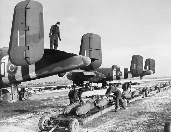 Artic Conditions On Belgium Airfield. R. A. F Ground crews bombing up R. A