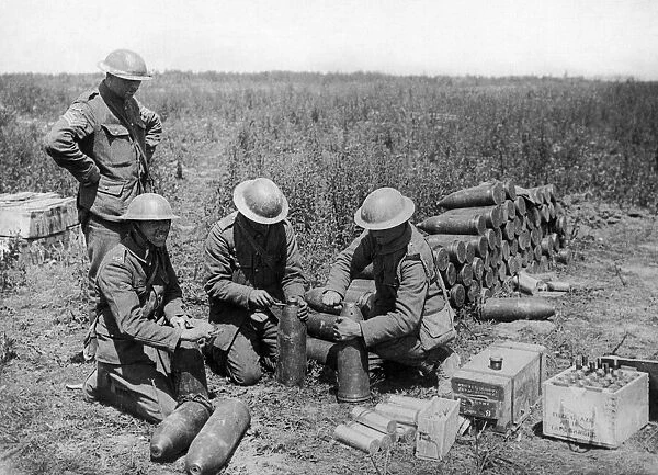 Artillerymen seen here setting the fuses for a bombardment of the German trenches