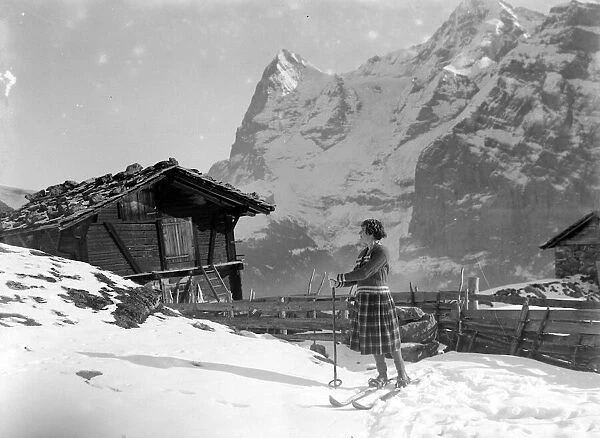 Artist Adrian Allison painting his wife on skis on the mountain slopes at Murren