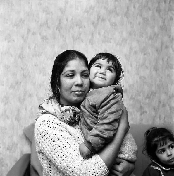 An Asian woman holding her little girl. December 1969 Z11628