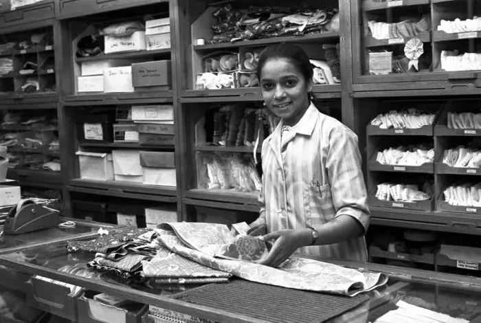 Framed Print : Asian woman working in a drapers shop in Smithford Way, Coventry Framed Print : Asian woman working in a drapers shop in Smithford Way, Coventry