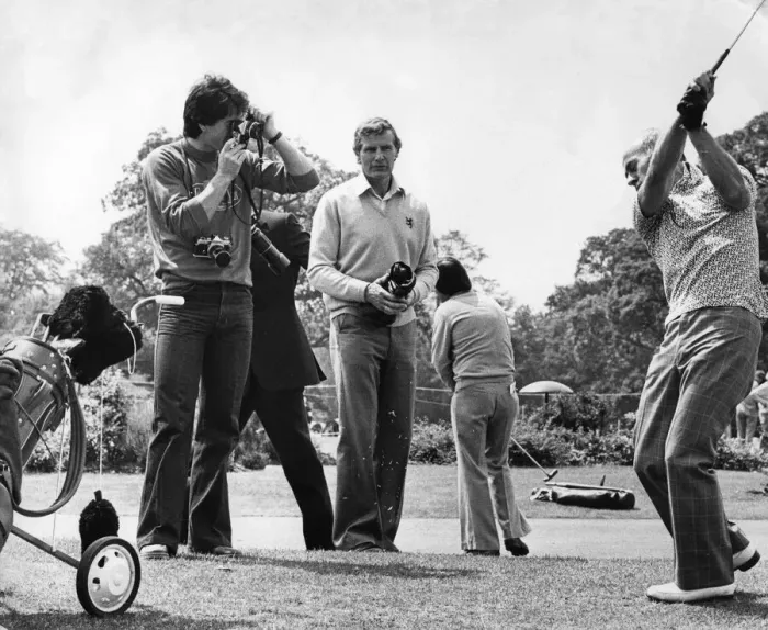 Framed Print : Aston Villa footballer Dennis Mortimer takes a photograph of manager Ron Saunders Framed Print : Aston Villa footballer Dennis Mortimer takes a photograph of manager Ron Saunders
