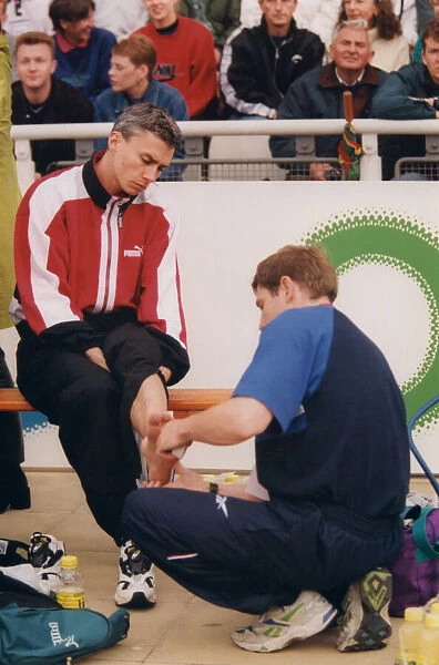 Athlete Jonathan Edwards Jonathan Edwards has his ankle strapped by a doctor