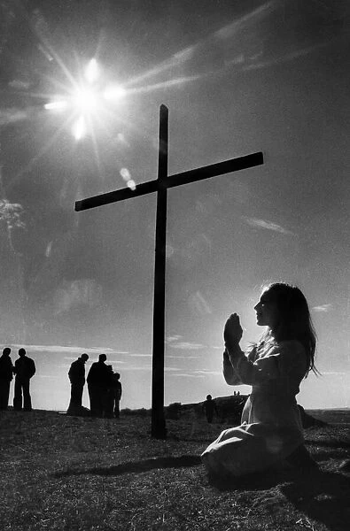Audrea Thompson prays by the cross mounted on Tunstall Hill, Sunderland, Tyne and Wear