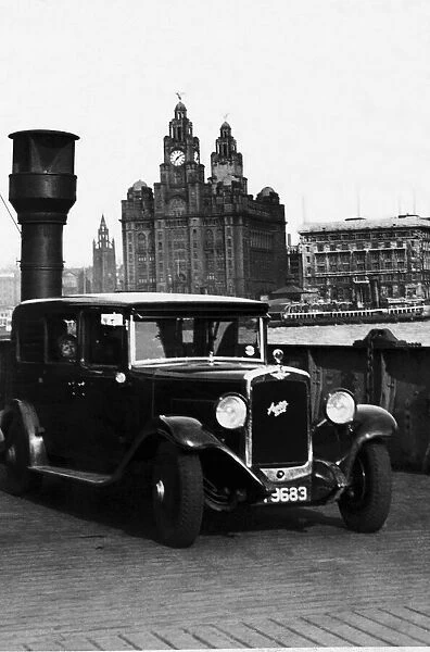 An Austin motor car crossing the River Mersey on a luggage boat in Liverpool