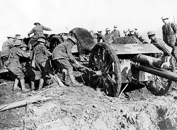 Austraian soldiers drag their gun through the mud of a French field. December 1917