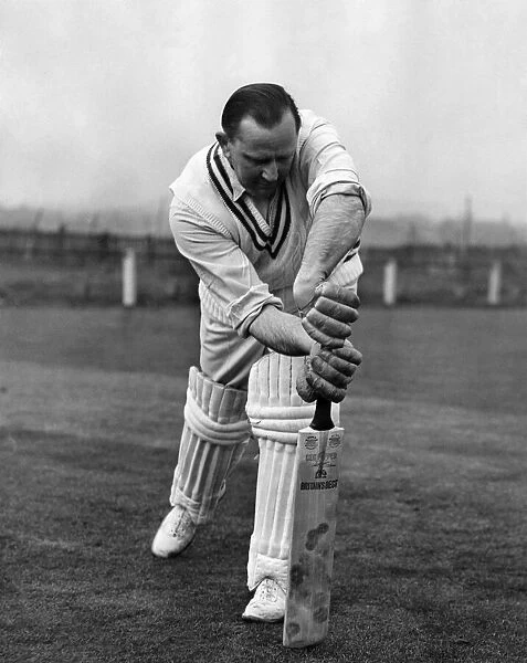 Australian cricketer Cecil Pepper demonstrates a stroke. April 1955