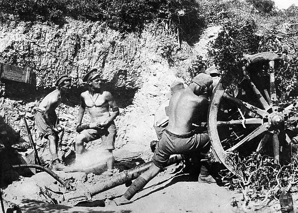 Australian gunners of the 9th Field Battery stripped to the waist operating the Number 4