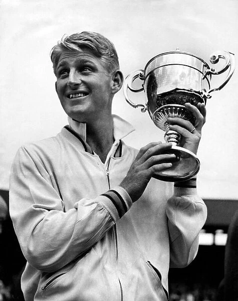 Australian tennis player Lew Hoad holding the championship cup after his finals match