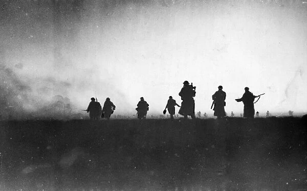 Australian troops advancing towards the defences of Bardia, in the light of the dawn