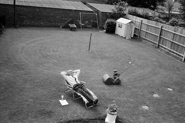 Automatic grass cutting. BOAC pilot Pat Alley demonstrating his mowing method in his