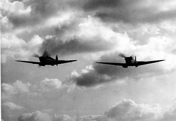 Aviation - Spitfire - Two Spitfires appear out of the clouds - somewhere in England