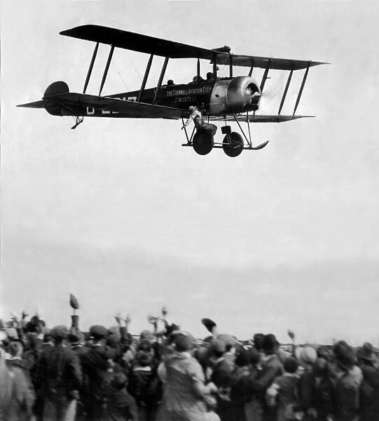 An Avro 504 biplane carries a daring wing walker of the Cornwall Aviation Co. Ltd