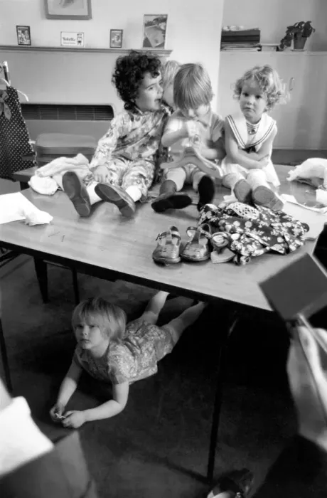 Framed Print : Away from the the crowd, this child model hides under the table It Framed Print : Away from the the crowd, this child model hides under the table It