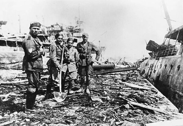 Axis troops clear up the debris on Spanish Mole, Tripoli, after an RAF raid