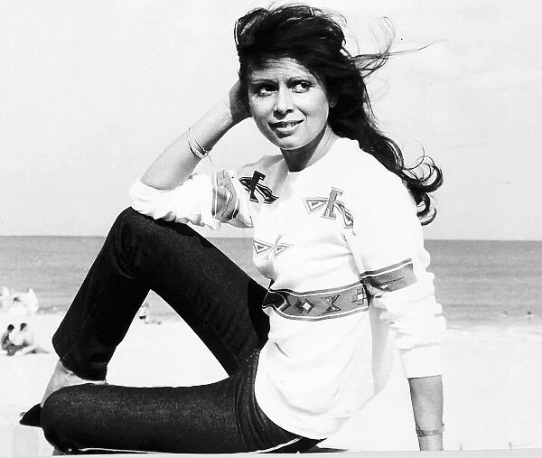 Ayshea Brough actress sitting on beach August 1980